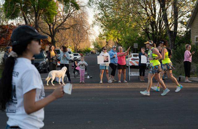 Residents of the College neighborhood cheer on runners during the Modesto Marathon in Modesto, Sunday, March 22, 2026.